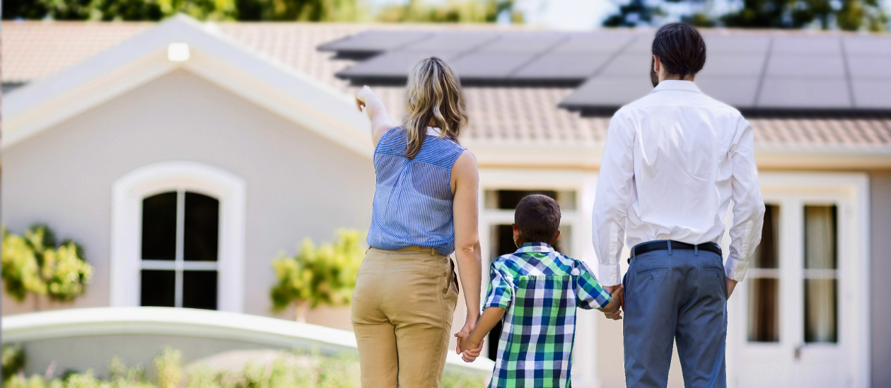 Family looking at the solar panels installed on their home